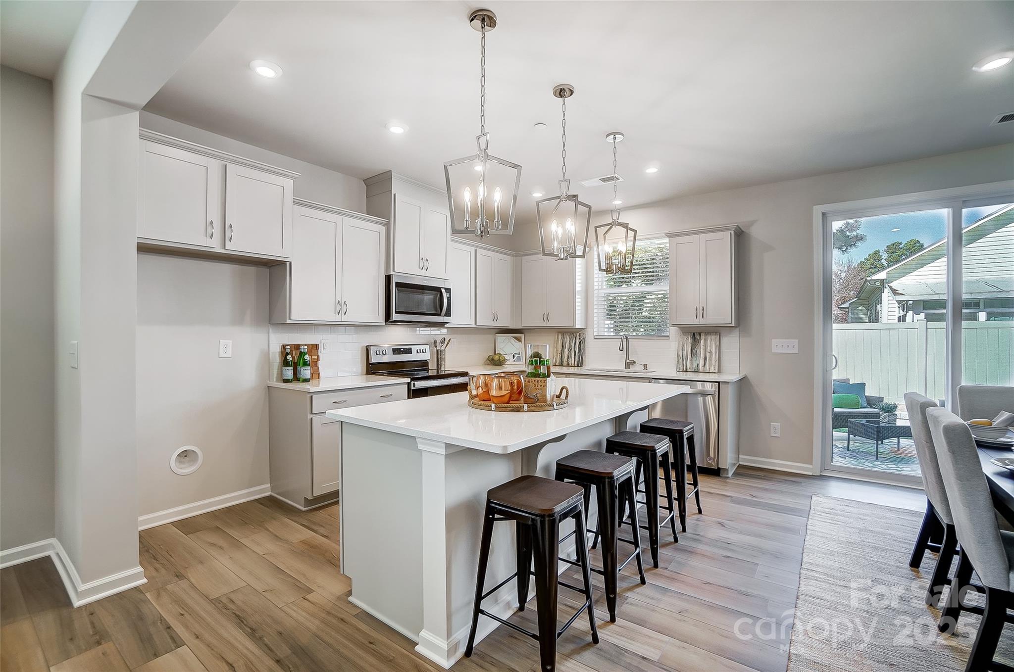 2475 Hedgecliff Road Kannapolis, NC 28083 - Photo 7 of 20 a kitchen with kitchen island granite countertop a sink a center island and appliances