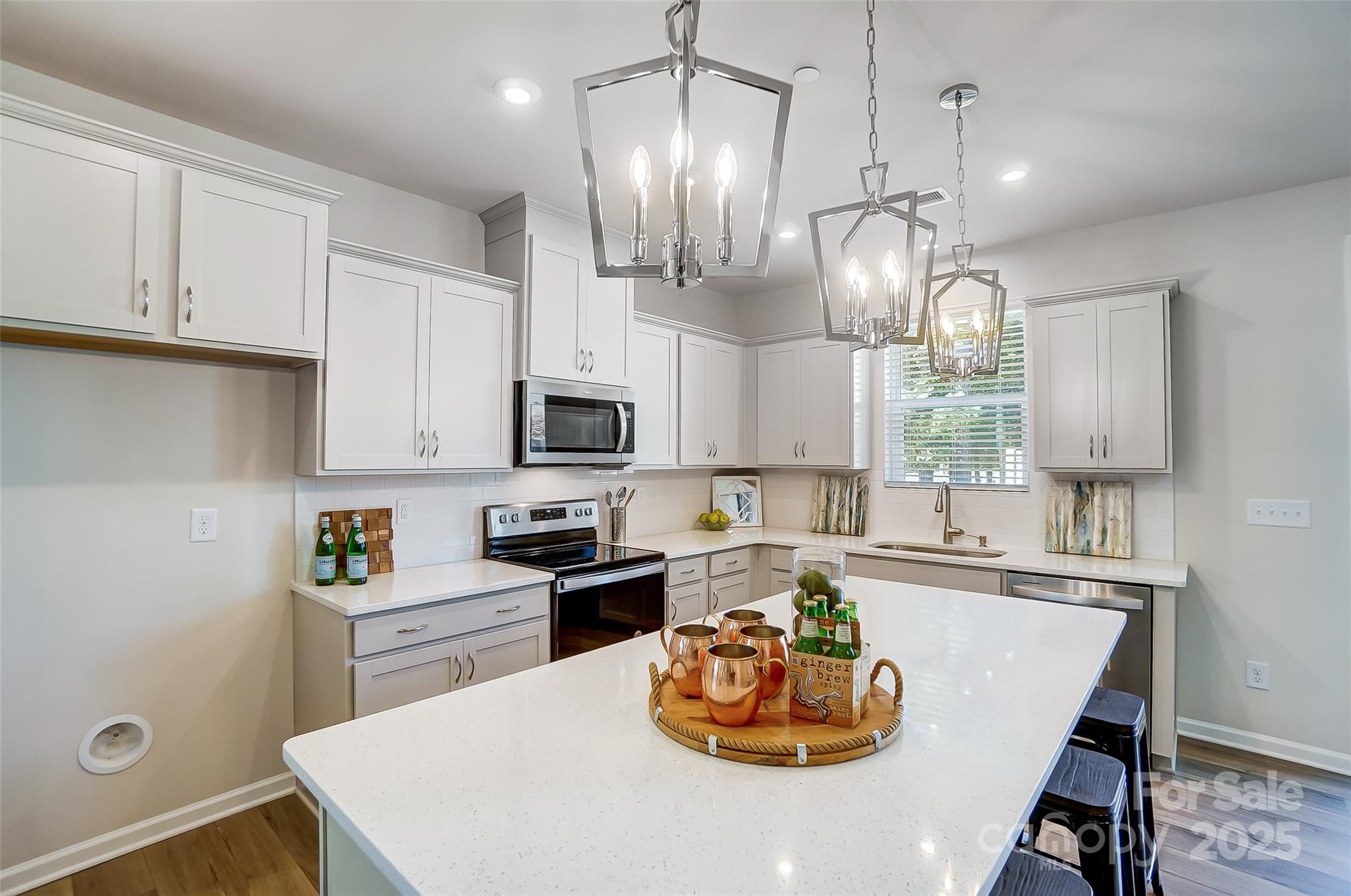 2475 Hedgecliff Road Kannapolis, NC 28083 - Photo 8 of 20 a kitchen with a sink a stove and chairs