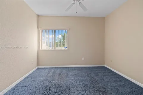 an empty room with fan and entrance