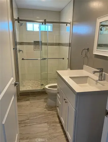 a bathroom with a toilet and a shower