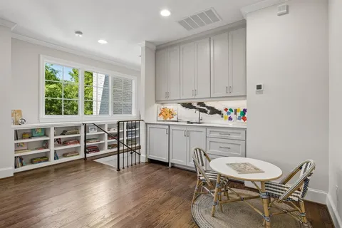 a kitchen that has a table and chairs in it