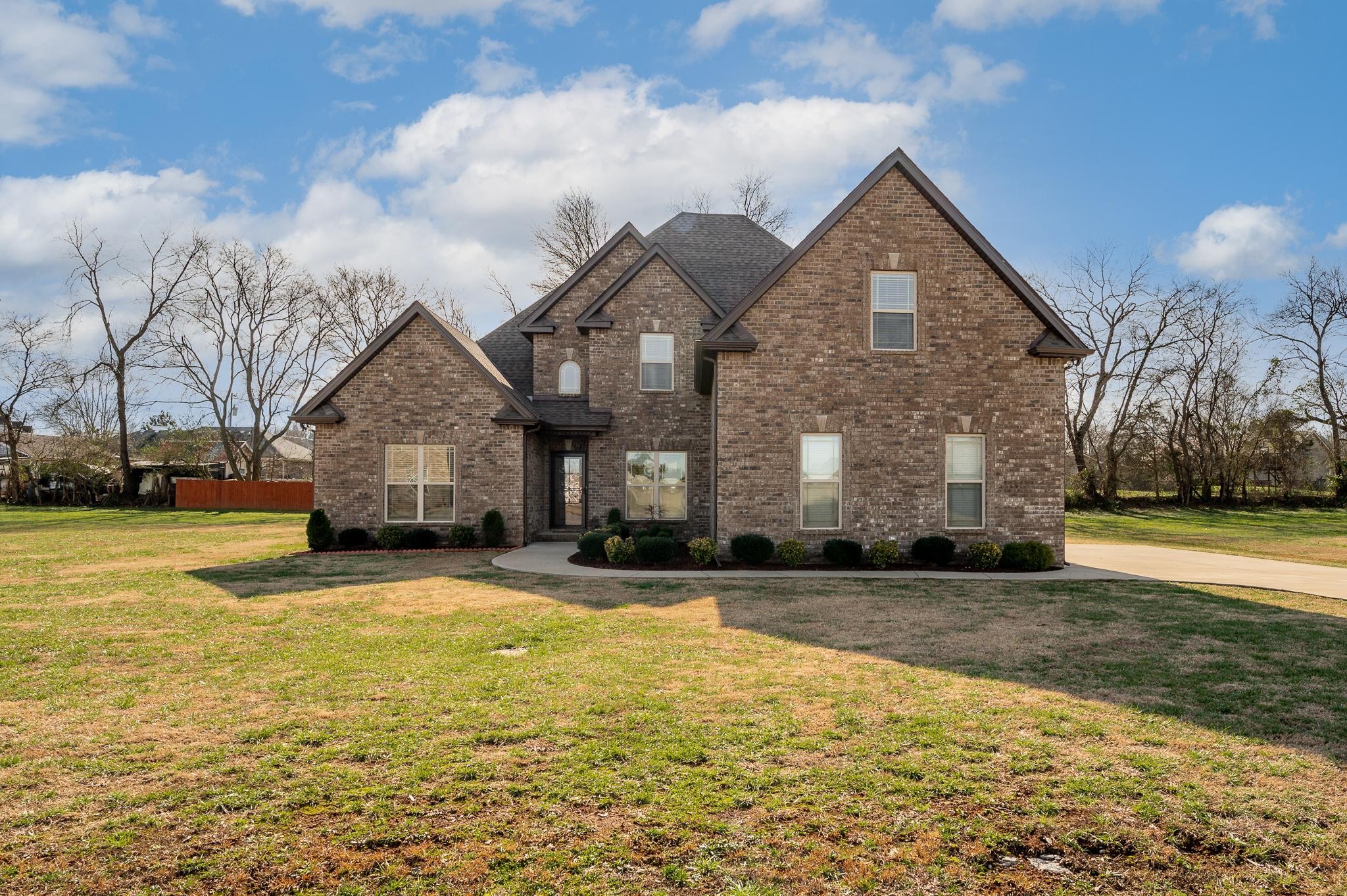a front view of house with yard and car parked