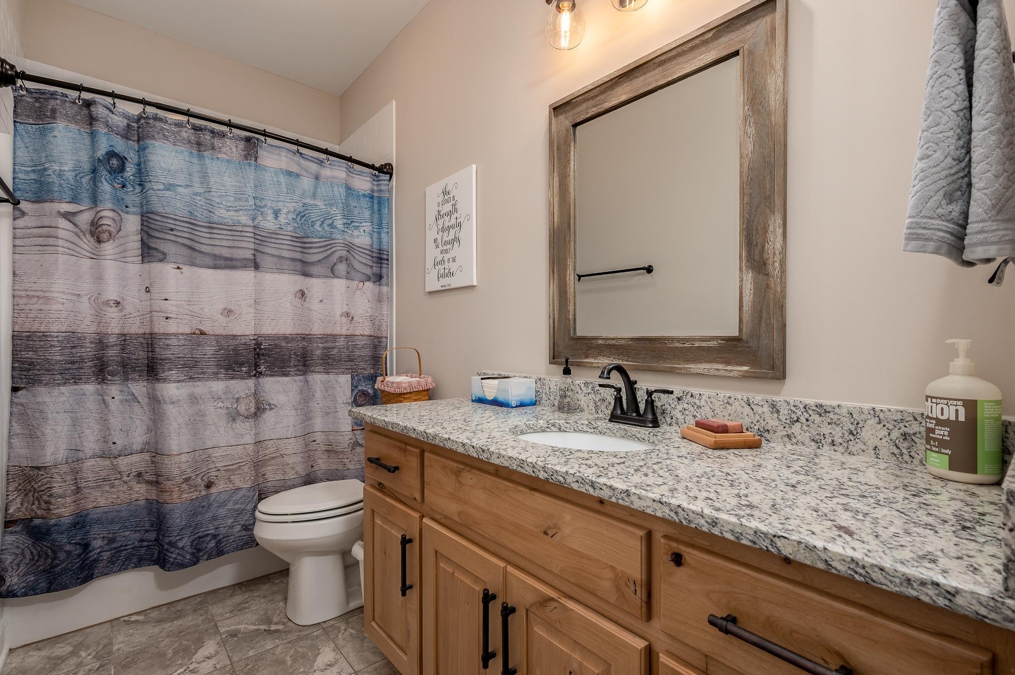 4306 Singleton Drive Murfreesboro, TN 37127 - Photo 14 of 34 a bathroom with a granite countertop sink a toilet and mirror