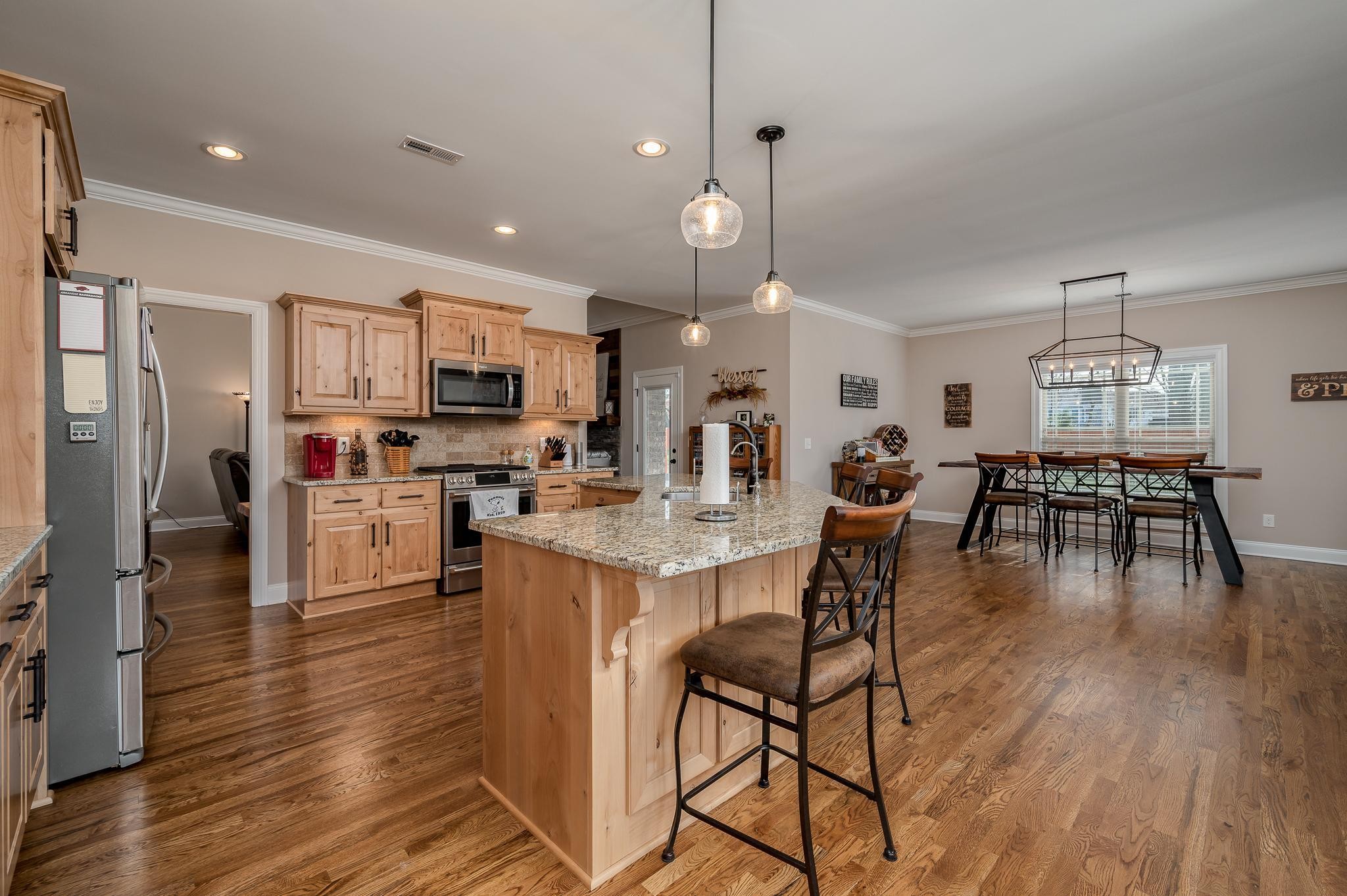 4306 Singleton Drive Murfreesboro, TN 37127 - Photo 17 of 34 a open kitchen view with stainless steel appliances refrigerator dining table and chairs