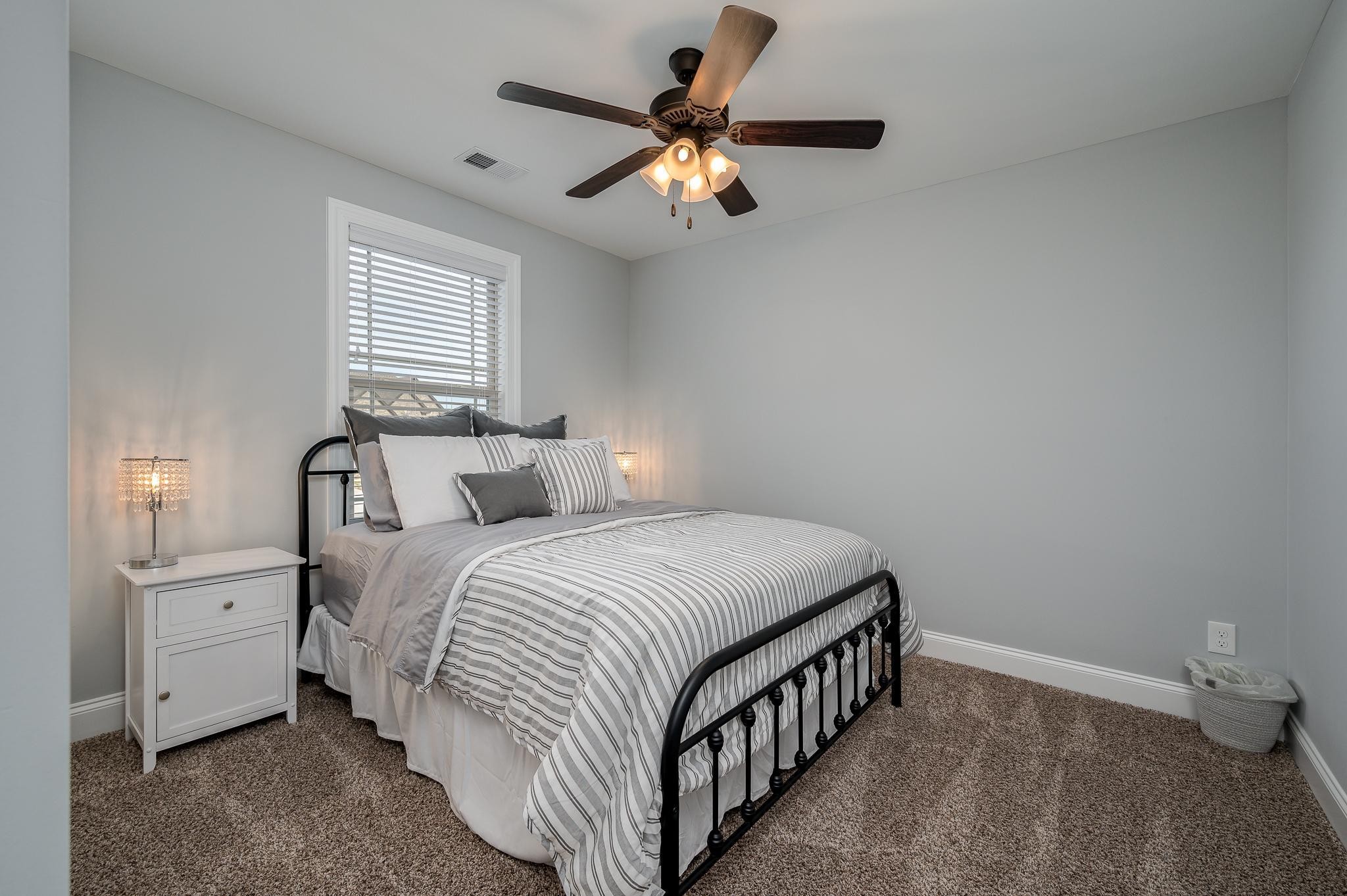 4306 Singleton Drive Murfreesboro, TN 37127 - Photo 24 of 34 a bedroom with a bed and a chandelier