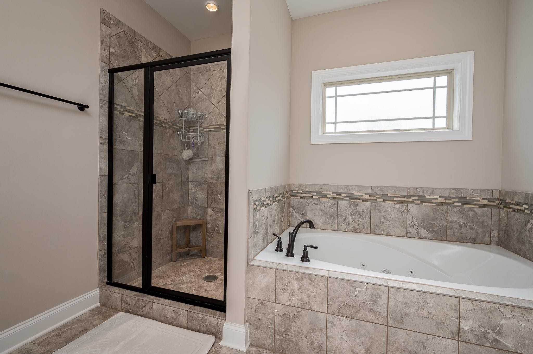 4306 Singleton Drive Murfreesboro, TN 37127 - Photo 9 of 34 a bathroom with a bathtub and shower