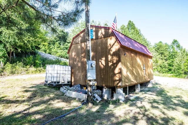 a view of backyard with cabin