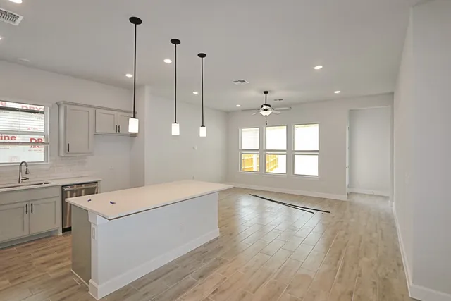 a large white kitchen with a large window