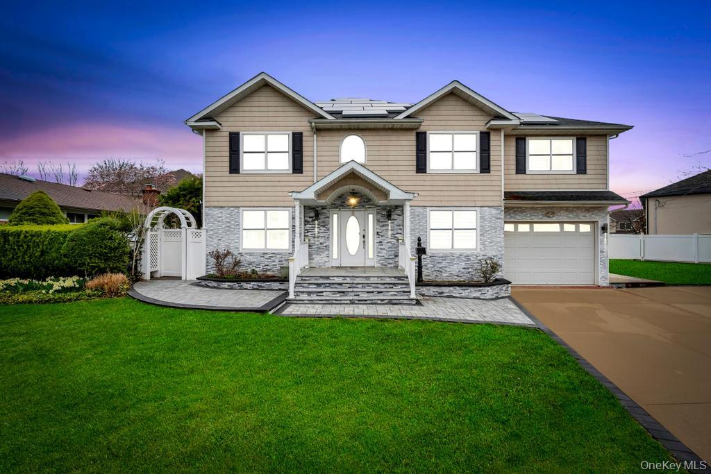 a front view of a house with a yard and garage