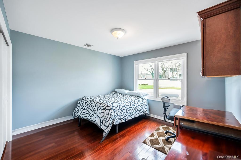 6 Garden Circle Syosset, NY 11791 - Photo 11 of 29 a bedroom with a bed and a window