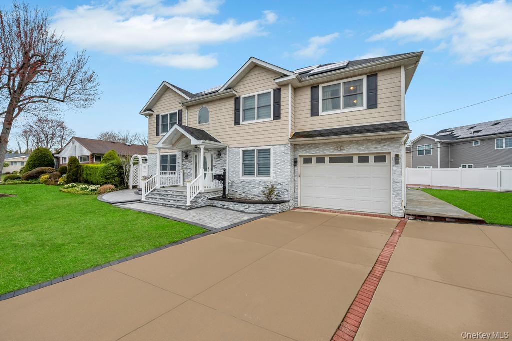 6 Garden Circle Syosset, NY 11791 - Photo 2 of 29 a front view of a house with yard and a garage