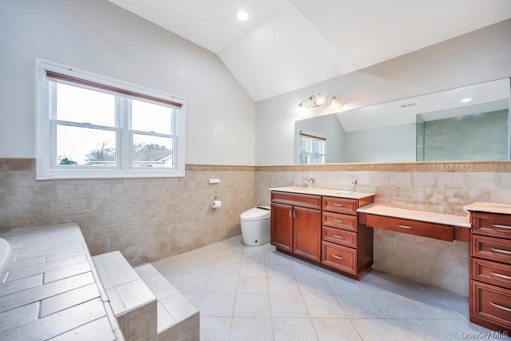 6 Garden Circle Syosset, NY 11791 - Photo 21 of 29 a spacious bathroom with a granite countertop sink a toilet and a bathtub