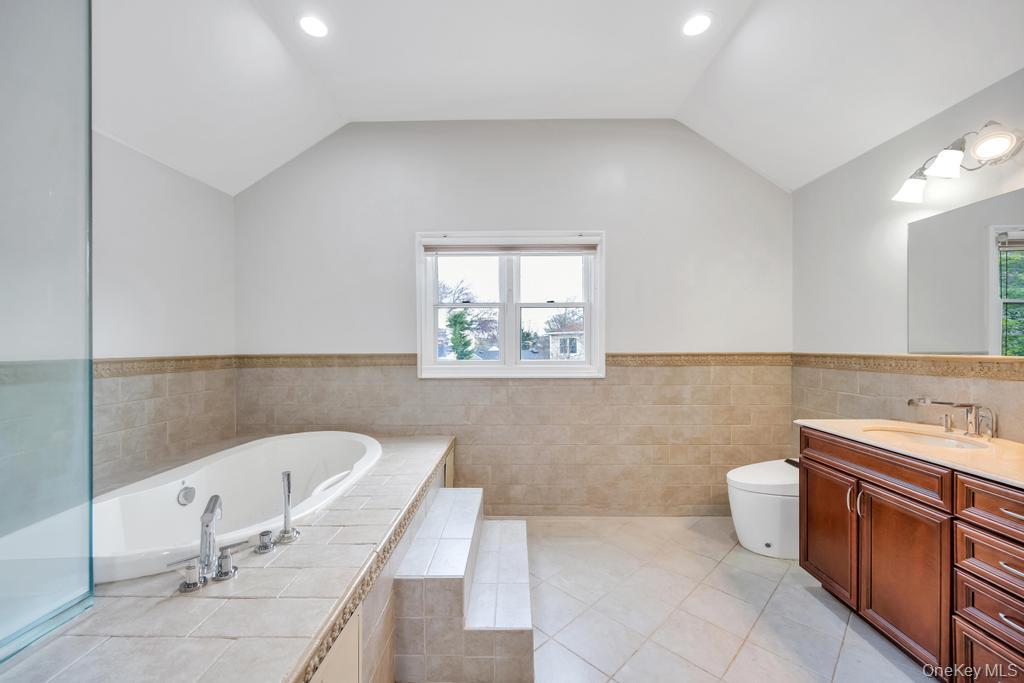 6 Garden Circle Syosset, NY 11791 - Photo 23 of 29 a bathroom with a tub a sink and a toilet