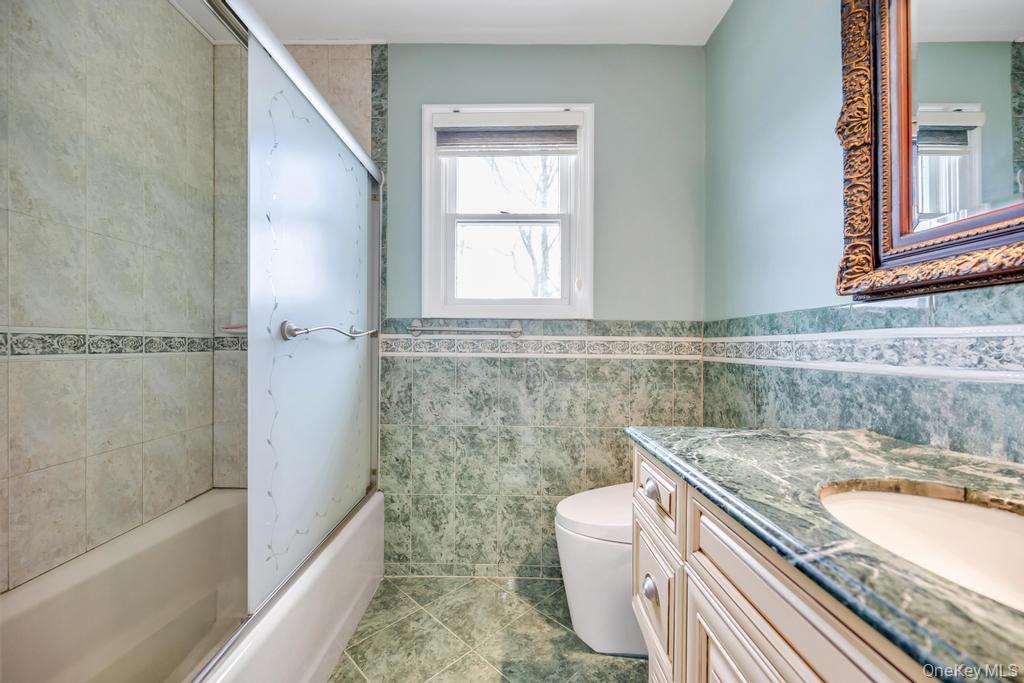 6 Garden Circle Syosset, NY 11791 - Photo 24 of 29 a bathroom with a granite countertop bathtub sink vanity and toilet