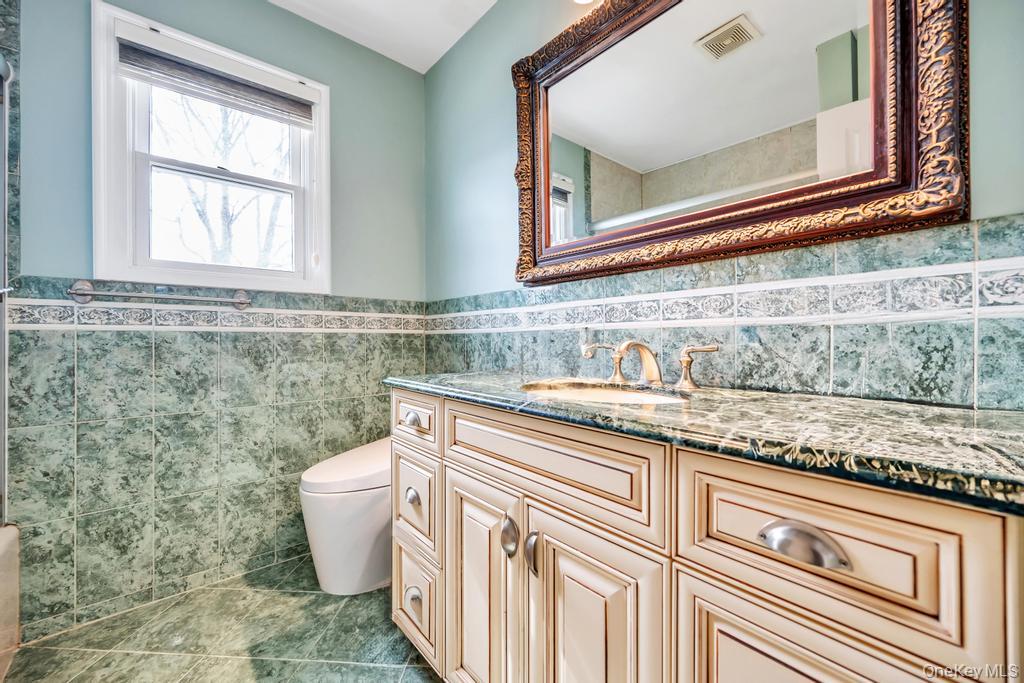 6 Garden Circle Syosset, NY 11791 - Photo 25 of 29 a bathroom with a sink a mirror and a toilet