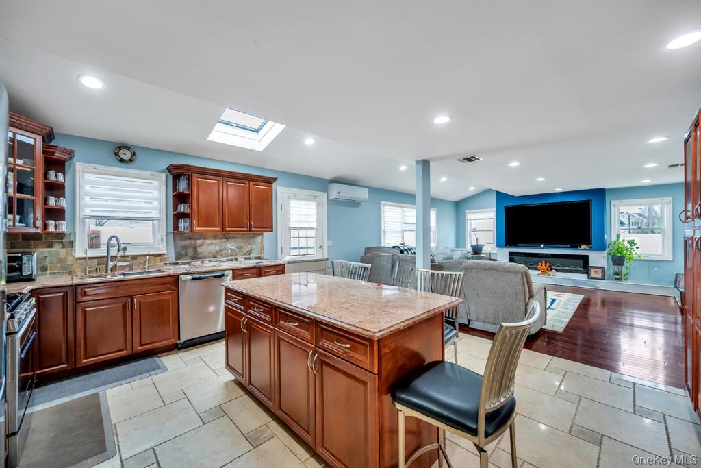6 Garden Circle Syosset, NY 11791 - Photo 4 of 29 a large kitchen with kitchen island a sink table and chairs