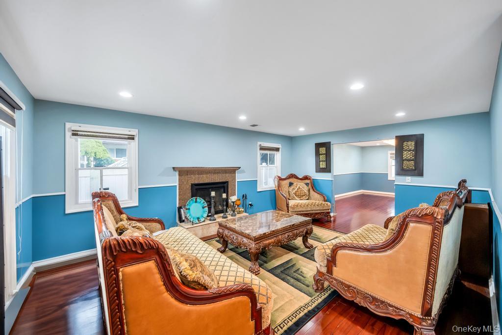 6 Garden Circle Syosset, NY 11791 - Photo 6 of 29 a living room with furniture two window and a fireplace