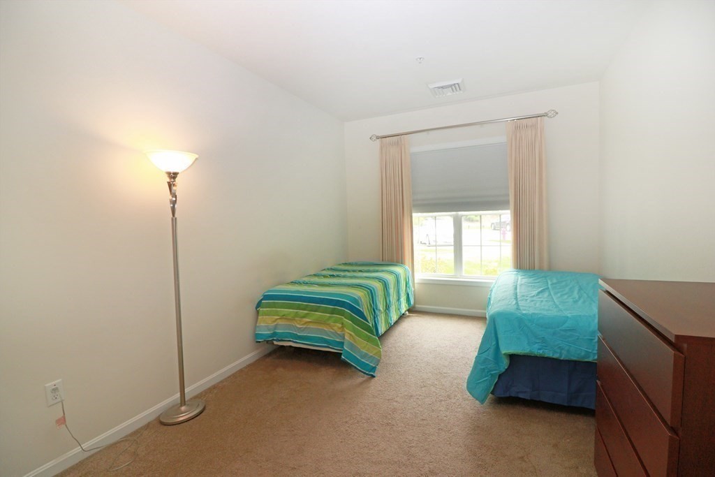 7 Morgan Drive, Unit 104 Natick, MA 01760 - Photo 13 of 26 a bedroom with bed and a window