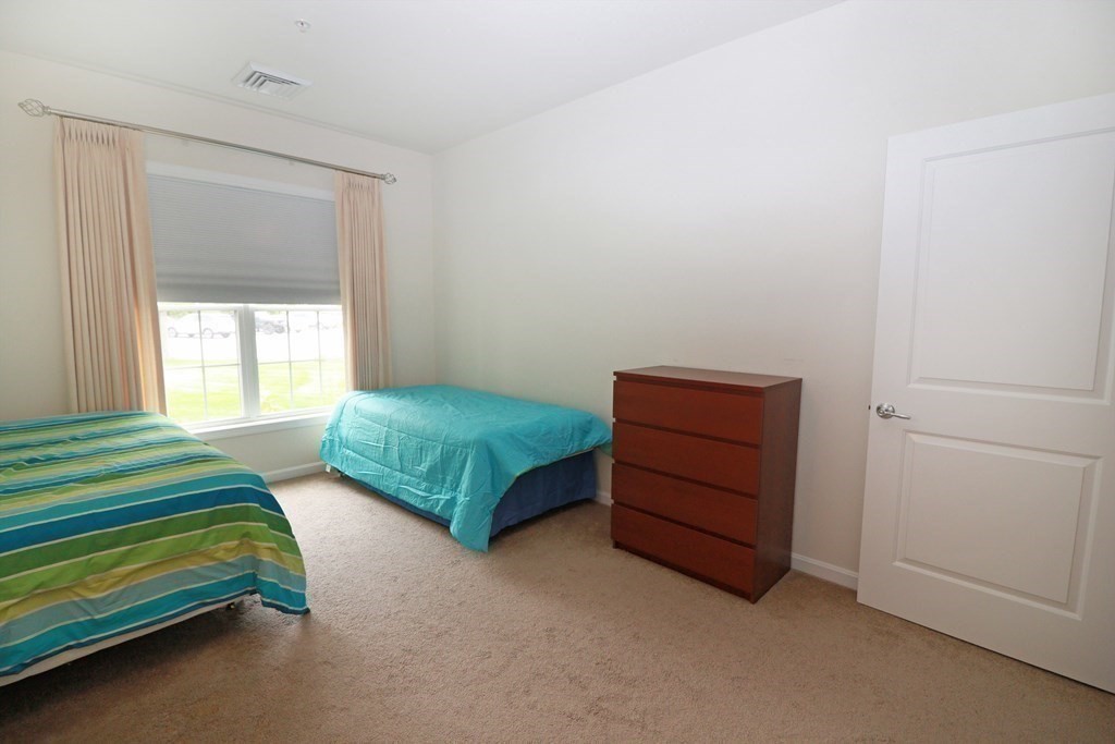7 Morgan Drive, Unit 104 Natick, MA 01760 - Photo 14 of 26 a bedroom with a bed and a window