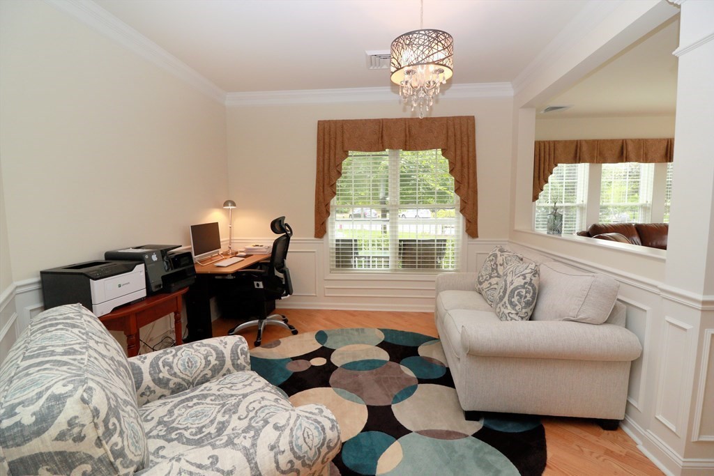 7 Morgan Drive, Unit 104 Natick, MA 01760 - Photo 2 of 26 a living room with furniture and a large window