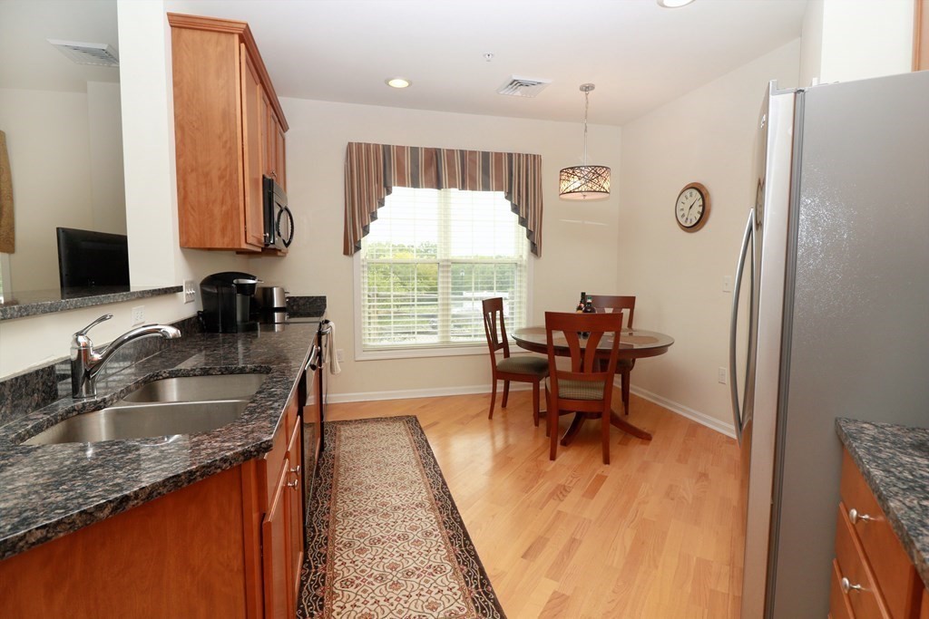 7 Morgan Drive, Unit 104 Natick, MA 01760 - Photo 4 of 26 a view of a kitchen area with furniture and a window