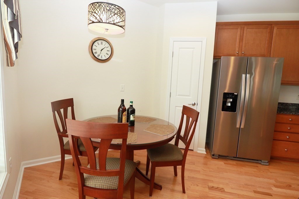 7 Morgan Drive, Unit 104 Natick, MA 01760 - Photo 5 of 26 a view of a dining room with furniture and wooden floor