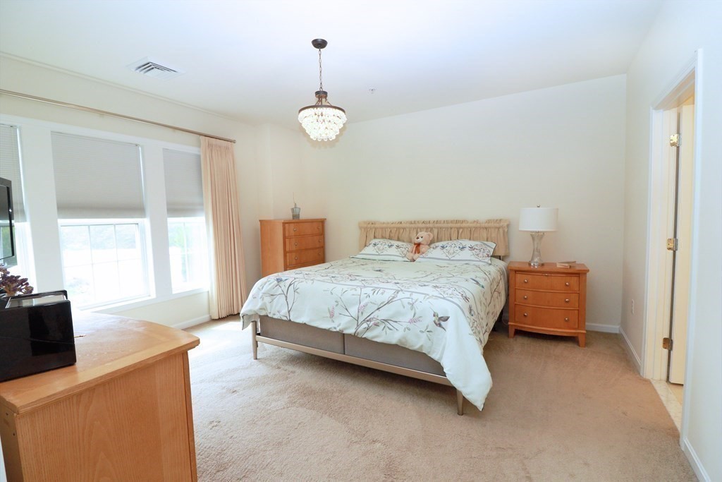 7 Morgan Drive, Unit 104 Natick, MA 01760 - Photo 9 of 26 a bedroom with a bed and window