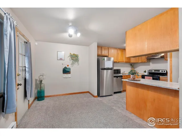 a kitchen with stainless steel appliances granite countertop a refrigerator a stove and a sink