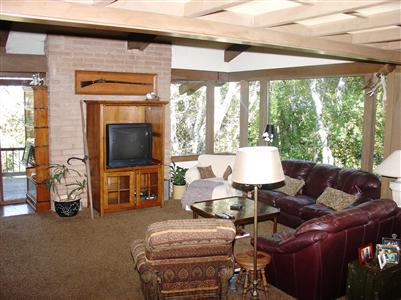 5767 Sonoma Mountain Road Santa Rosa, CA 95404 - Photo 5 of 11 a living room with furniture a flat screen tv and floor to ceiling window