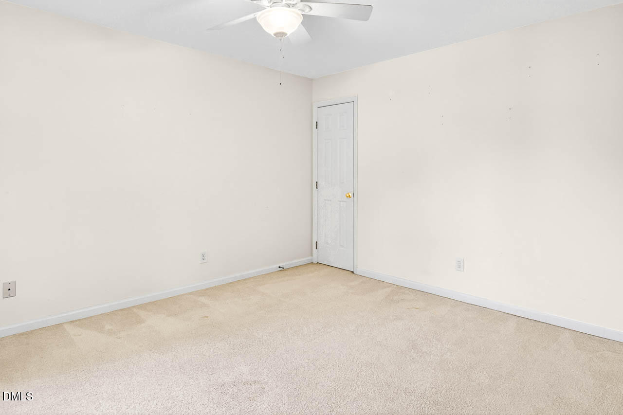 2209 Lodestar Drive Raleigh, NC 27615 - Photo 35 of 50 an empty room with a chandelier fan