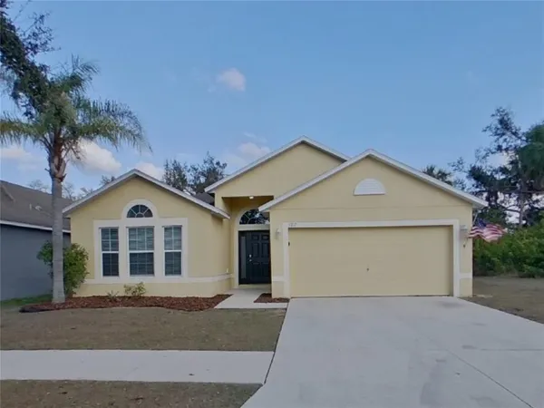 a view of a house with a yard and garage