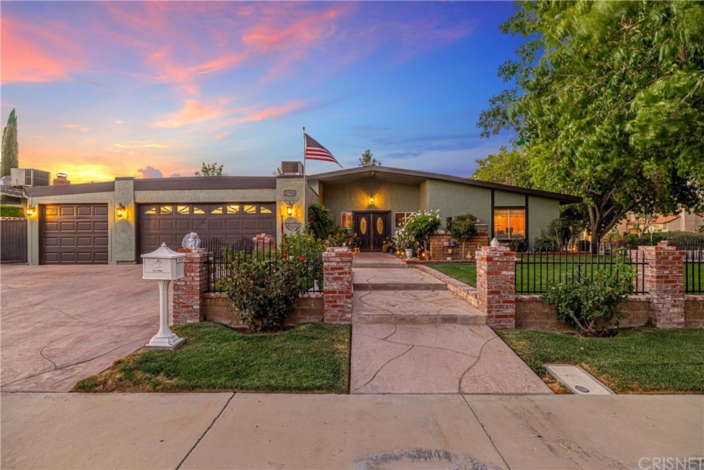 a view of a patio with table and chairs under an umbrella