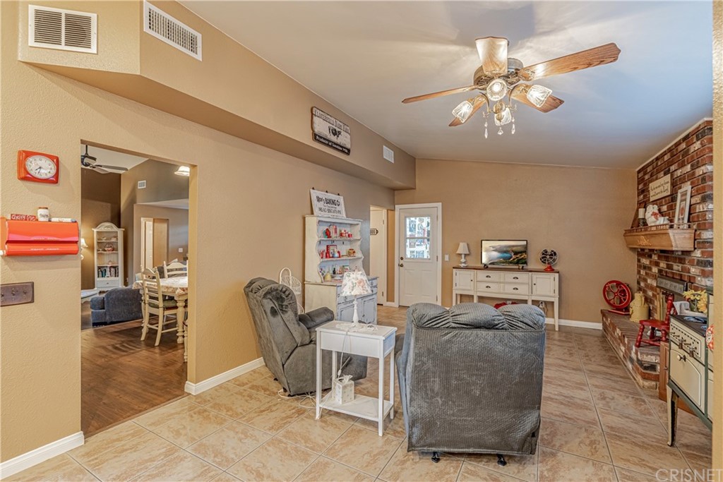 2701 West Ave J4 Lancaster, CA 93536 - Photo 16 of 46 a living room with furniture and a chandelier