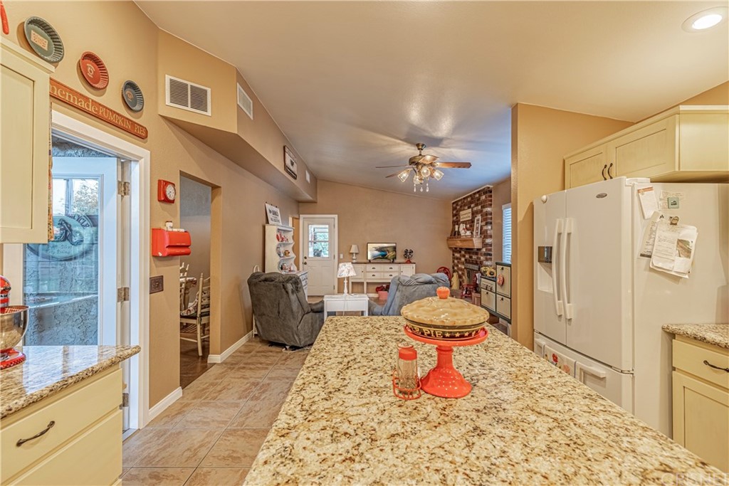 2701 West Ave J4 Lancaster, CA 93536 - Photo 18 of 46 a living room with stainless steel appliances furniture a rug and a kitchen view