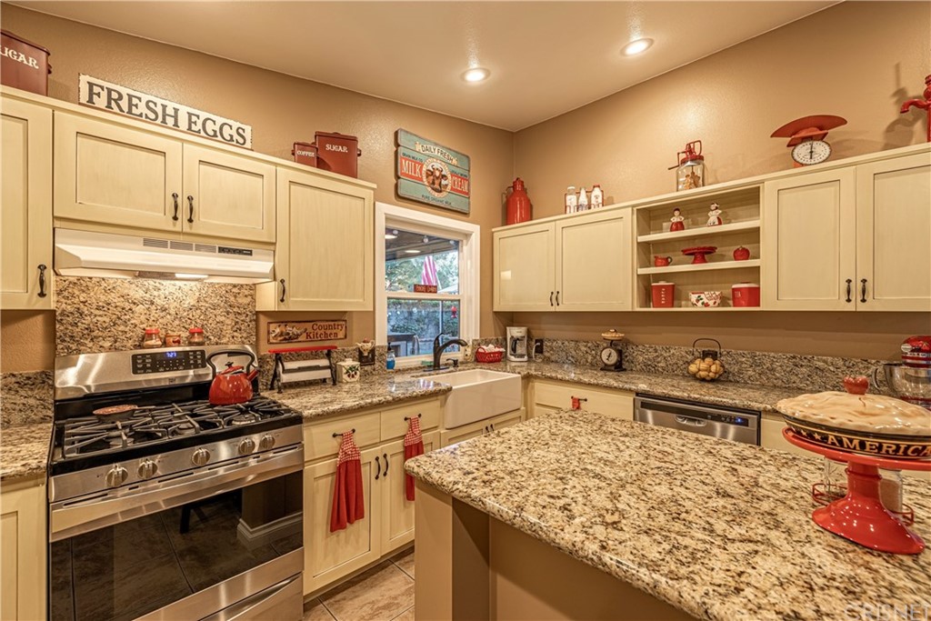 2701 West Ave J4 Lancaster, CA 93536 - Photo 19 of 46 a kitchen with a stove a sink and a refrigerator