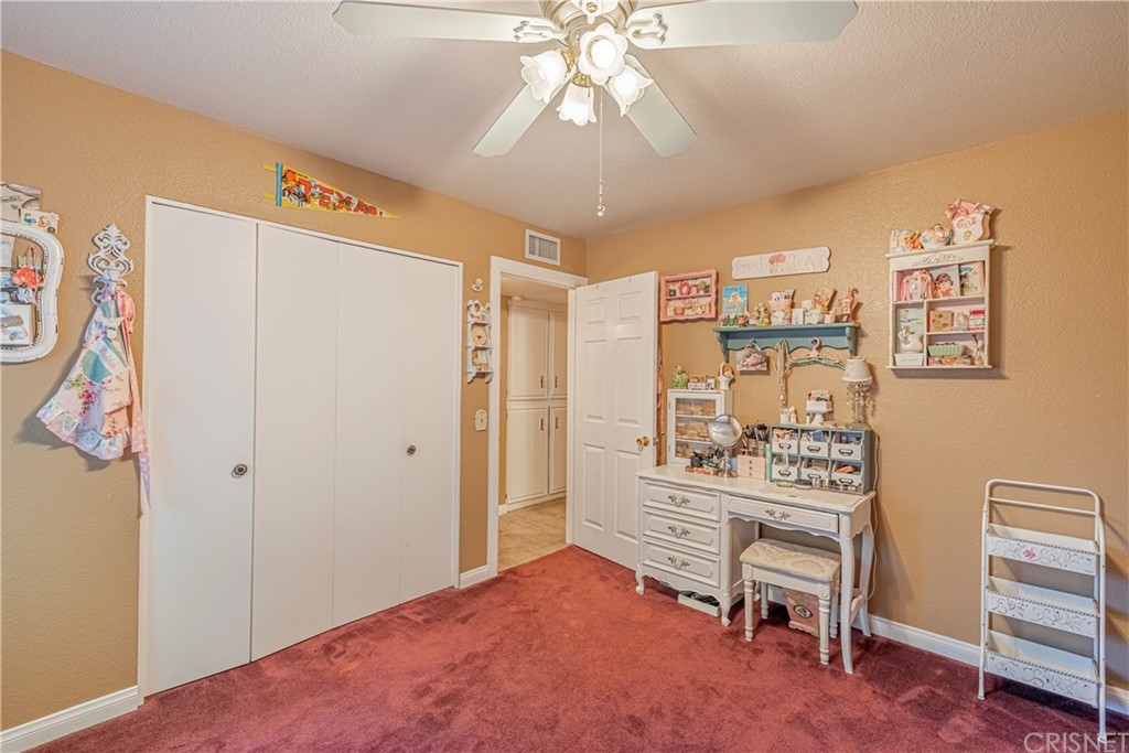 2701 West Ave J4 Lancaster, CA 93536 - Photo 24 of 46 a bedroom with furniture and a chandelier