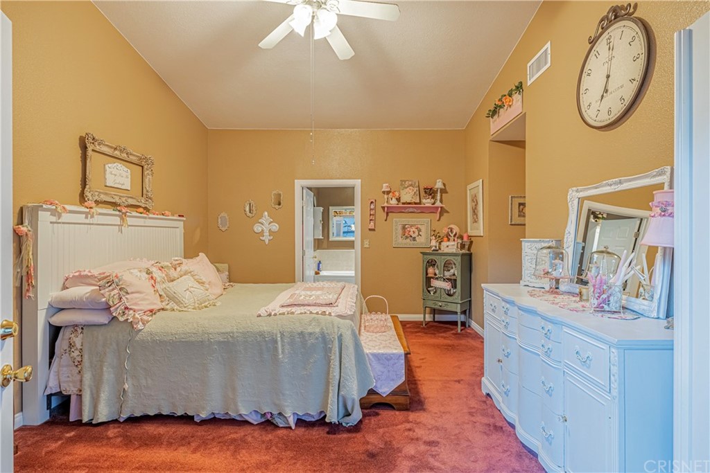 2701 West Ave J4 Lancaster, CA 93536 - Photo 30 of 46 a bedroom with a bed and a chandelier