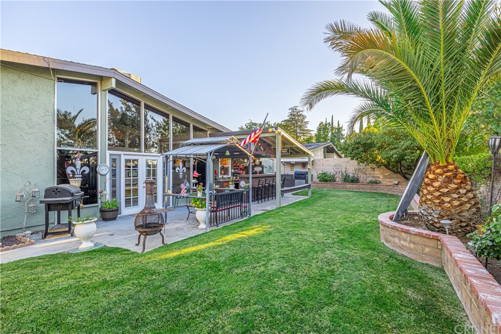 2701 West Ave J4 Lancaster, CA 93536 - Photo 35 of 46 a view of house with a big yard and potted plants