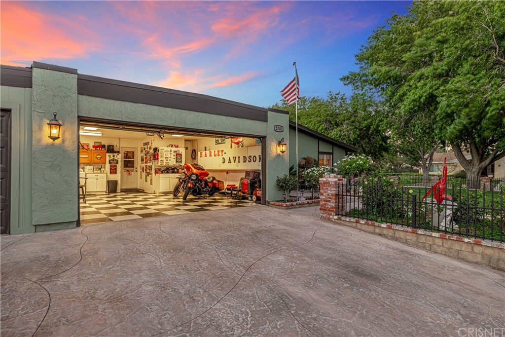 2701 West Ave J4 Lancaster, CA 93536 - Photo 45 of 46 a view of a house with potted plants and a large tree