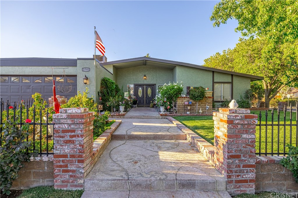 2701 West Ave J4 Lancaster, CA 93536 - Photo 5 of 46 a front view of a house with a yard and potted plants
