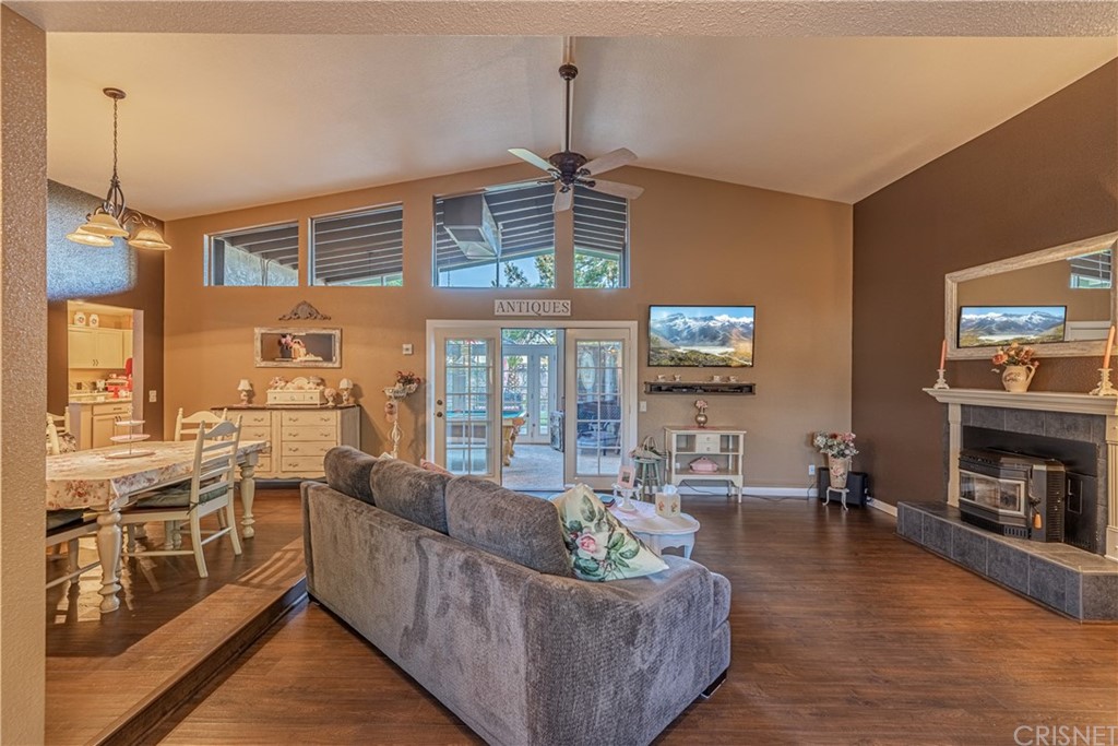 2701 West Ave J4 Lancaster, CA 93536 - Photo 7 of 46 a living room with furniture a fireplace and a flat screen tv