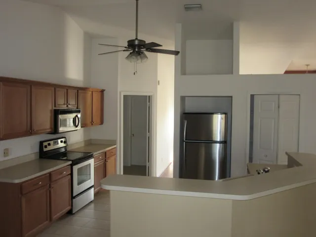 a kitchen with stainless steel appliances a refrigerator stove and microwave