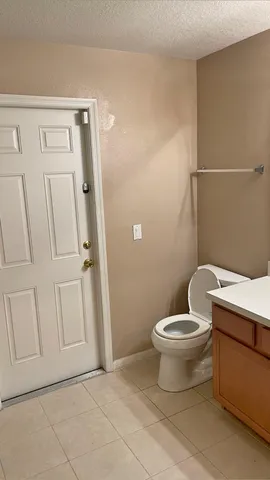 a white toilet sitting next to a bathroom sink