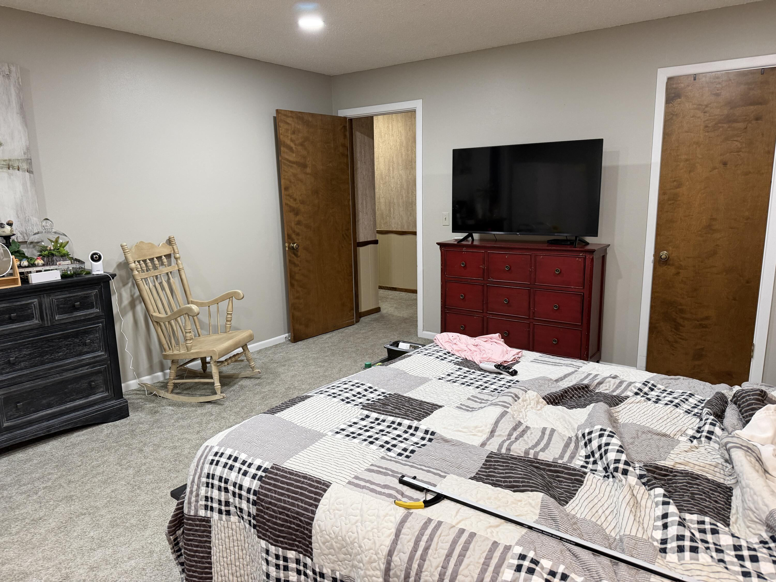 1603 South 8th Street Lamesa, TX 79331 - Photo 18 of 39 a bedroom with a bed and a flat screen tv