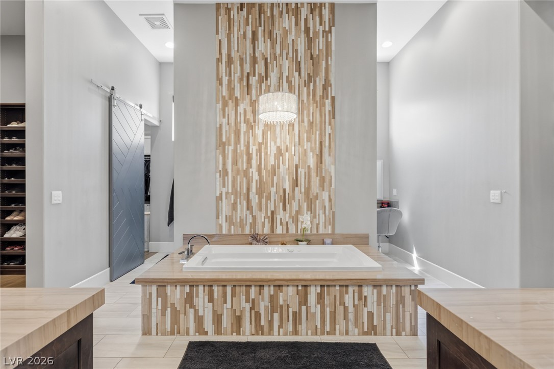 5 Crystal Tree Pass Henderson, NV 89052 - Photo 22 of 67 A spacious bathroom offers a deep soaking tub, perfect for relaxation after a long day.