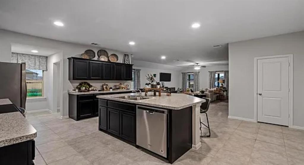 a kitchen with stainless steel appliances a sink stove and refrigerator