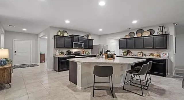 a kitchen with stainless steel appliances a stove sink microwave and cabinets