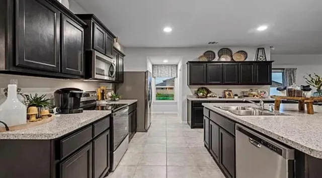 a en suite bathroom with a granite countertop sink and a mirror