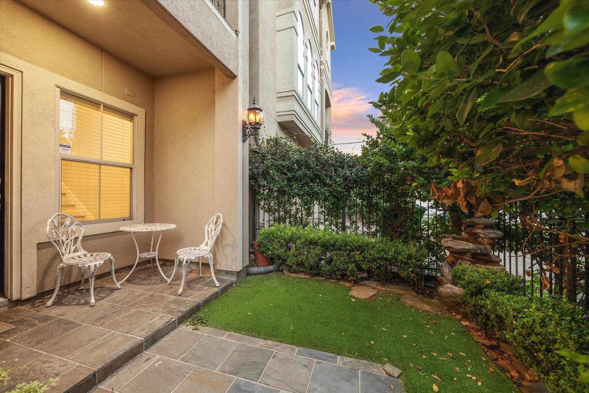 a view of a patio with table and chairs and potted plants