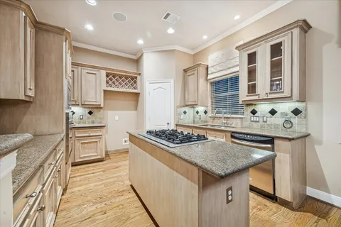 a kitchen with stainless steel appliances granite countertop a stove and a sink